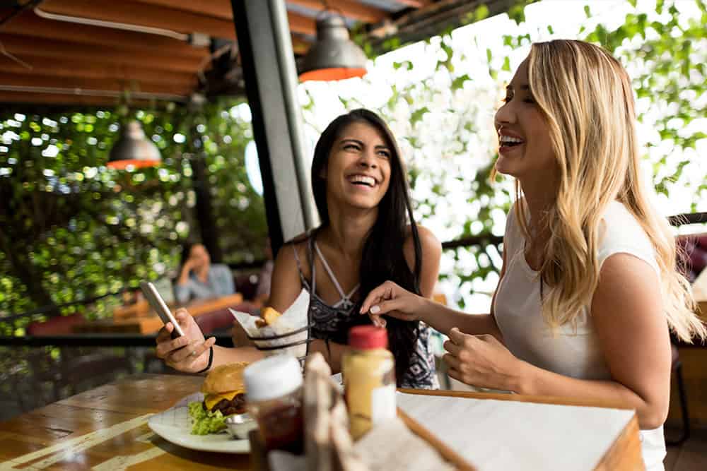 Two women at a restaurant laughing